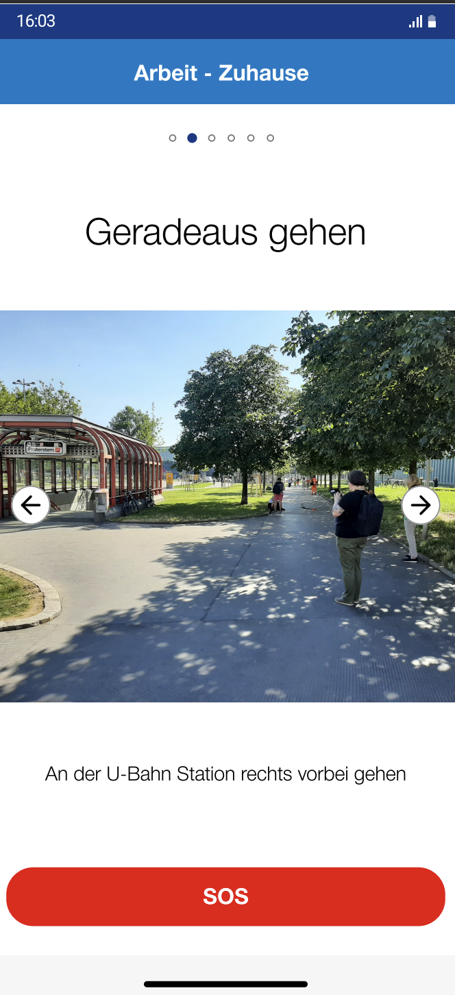 App screen showing a route step with a photo of the next landmark and an SOS button.