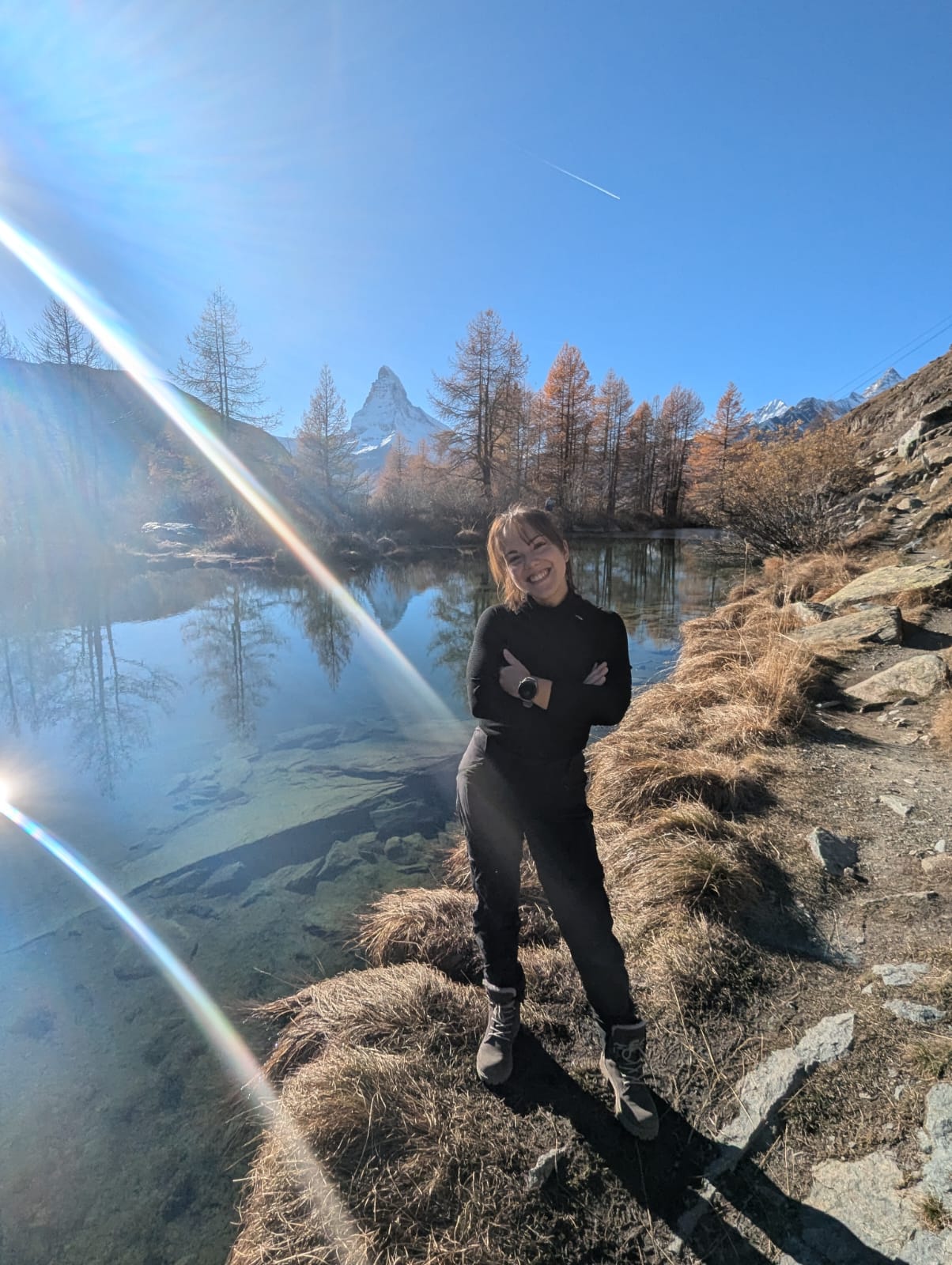 Désirée S. by an alpine lake with the Matterhorn behind her.